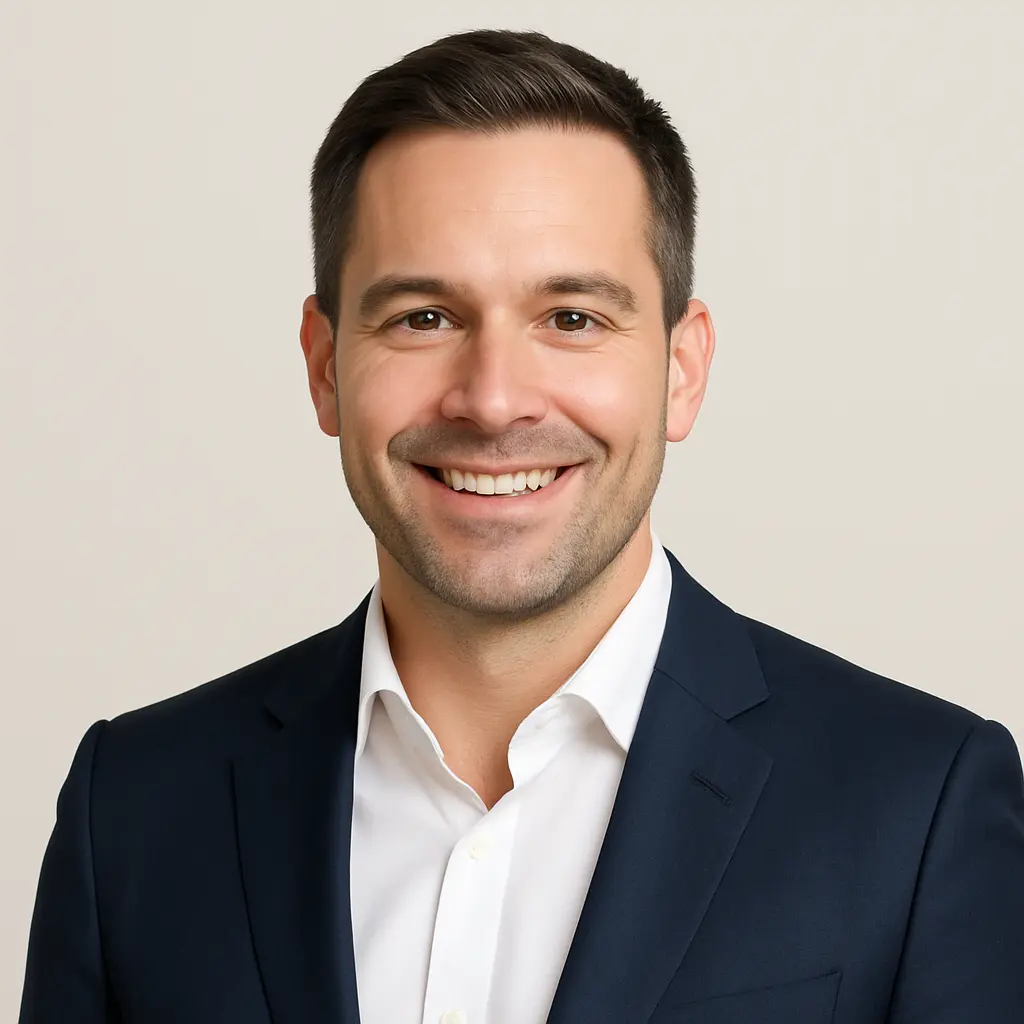Professional headshot of Michael R., smiling man in a navy suit and white shirt, used for Perun Chauffeurs Gatwick transfer testimonial.